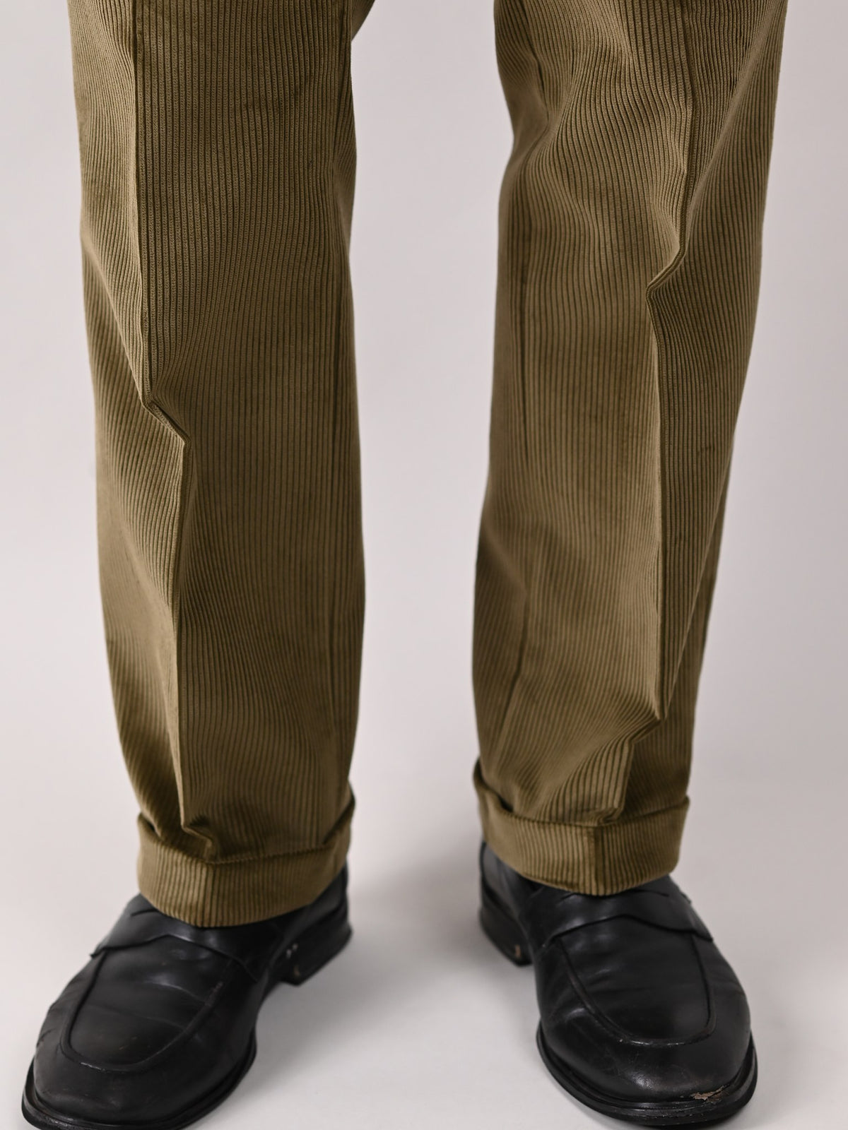 Brisbane Moss corduroy trousers in Drab, khaki cotton, detail of the turn-ups — John Crocket