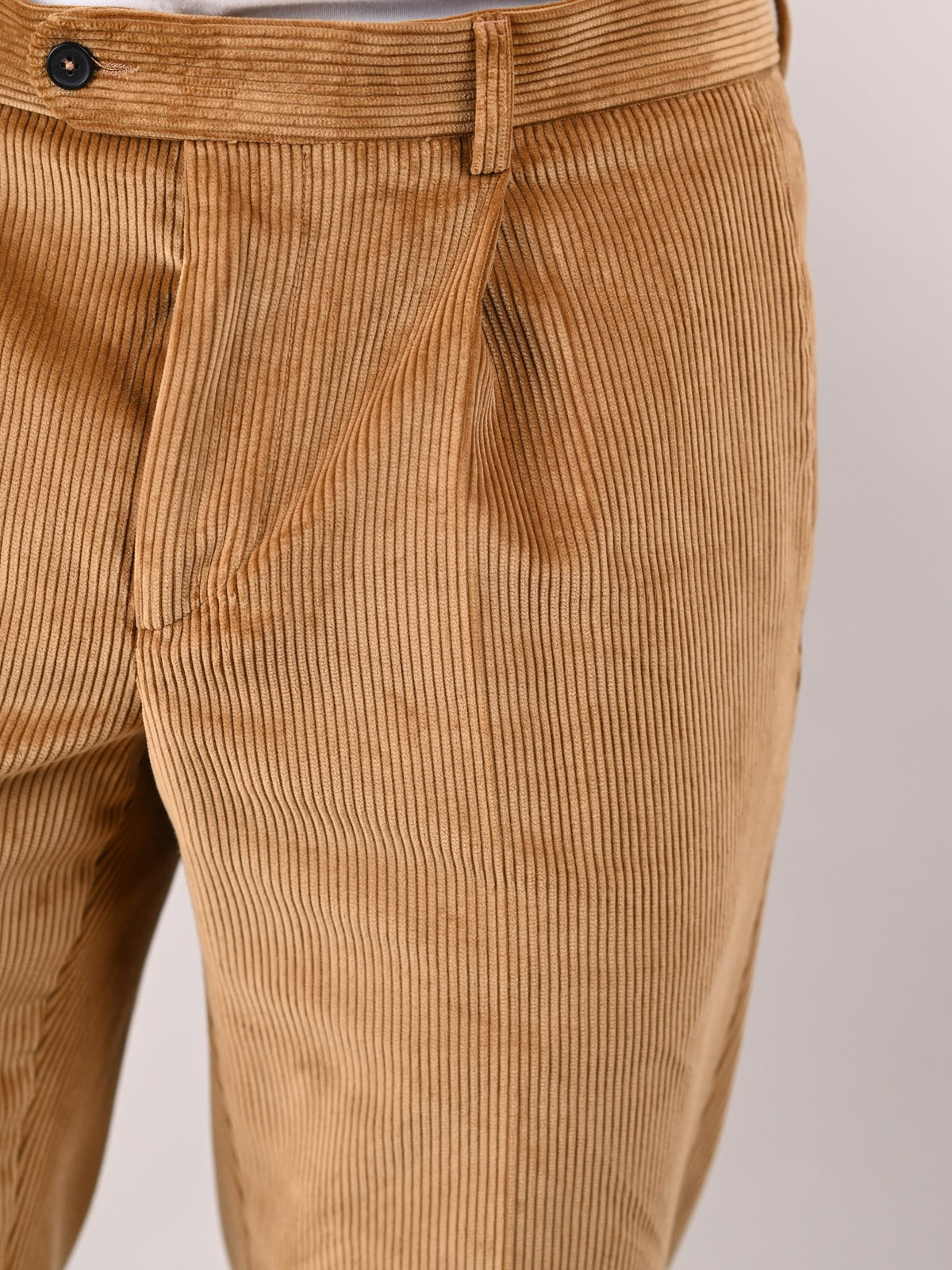 Brisbane Moss corduroy trousers in Fawn, sandy brown cotton, detail of the pleated front — John Crocket