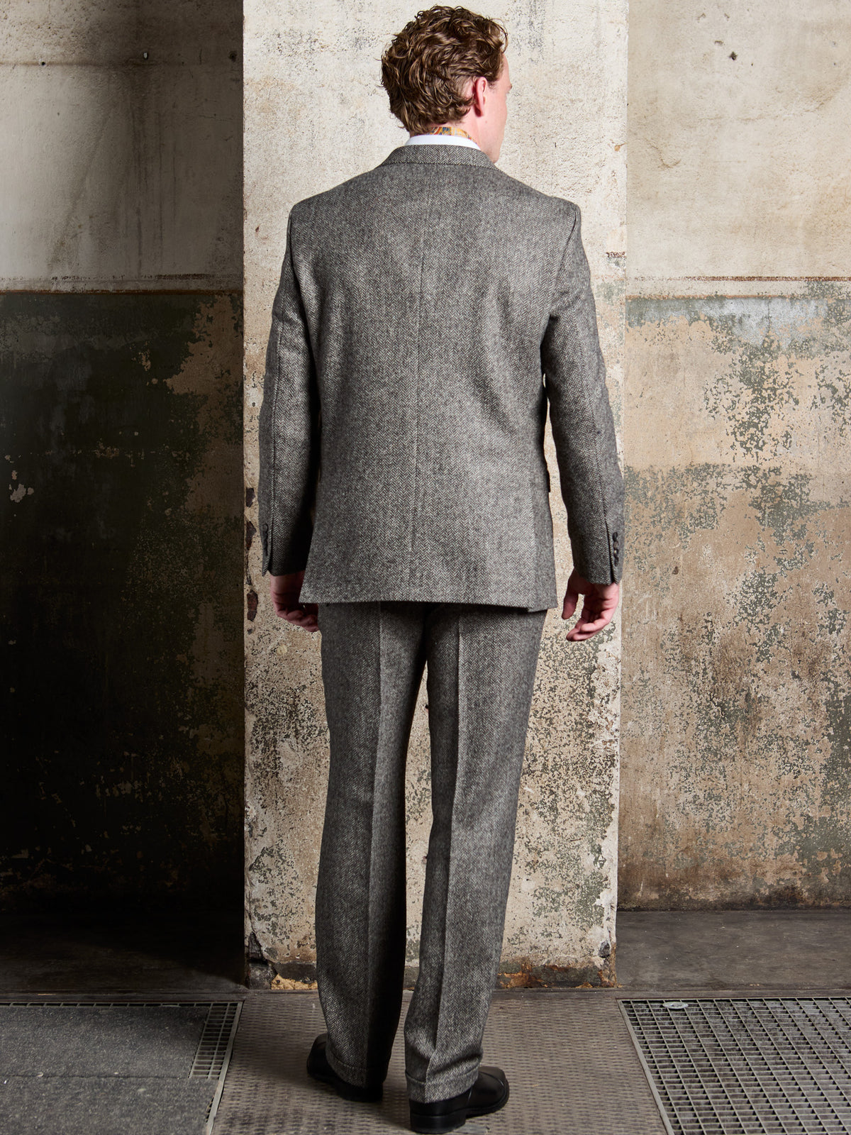 Dark Grey herringbone tweed suit in Moon Tweed, back view of jacket and trousers – John Crocket