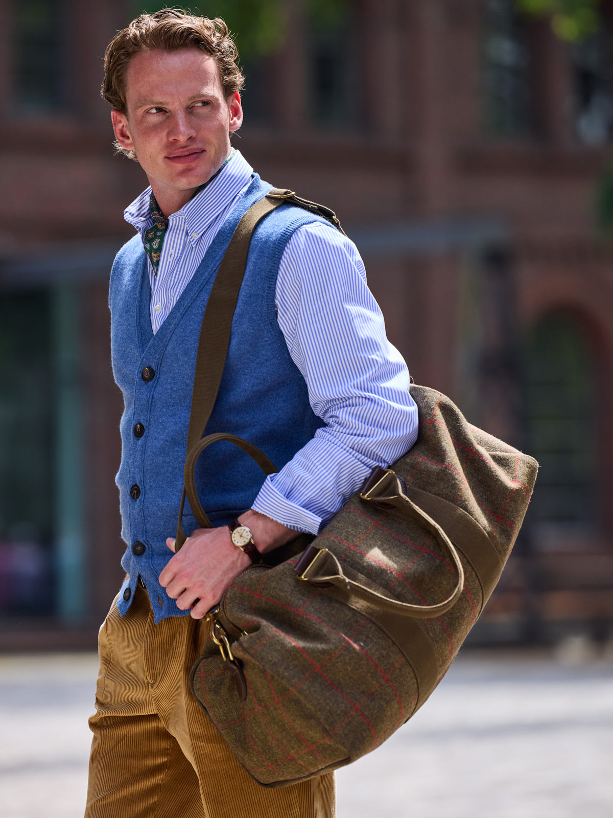 Weekender in Lovat Tweed, Olive, carried over the shoulder, side view with handles and strap – John Crocket
