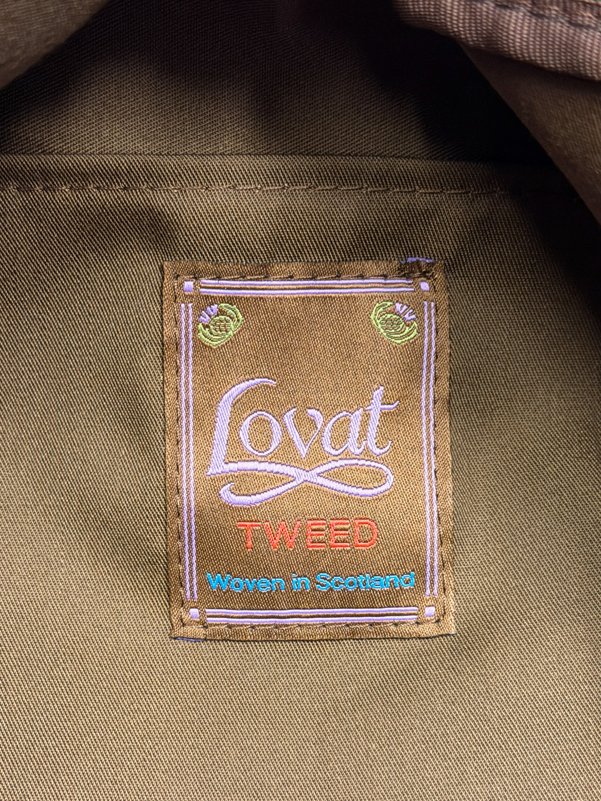 Lovat Tweed weekender, detail of the inside label reading “Lovat Tweed, Woven in Scotland” – John Crocket