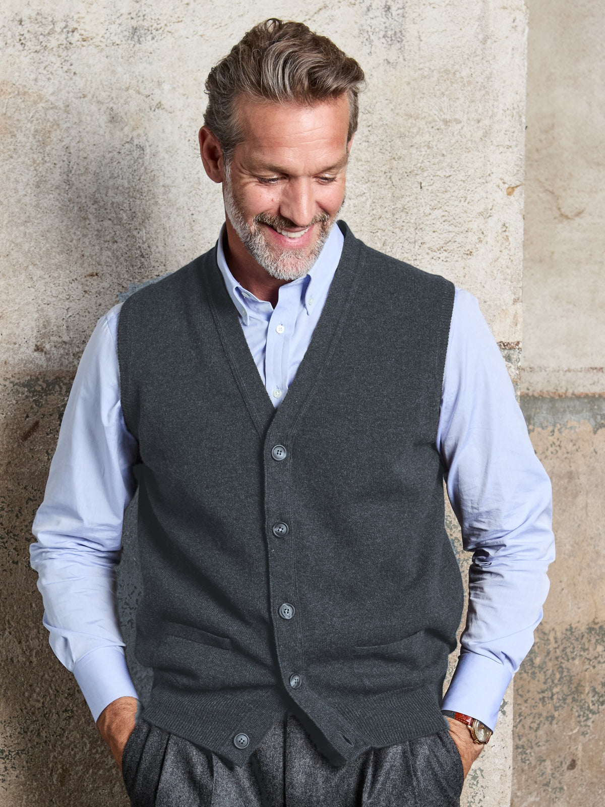 Lambswool sleeveless cardigan with button placket in Charcoal, V-neck, worn, front view – John Crocket
