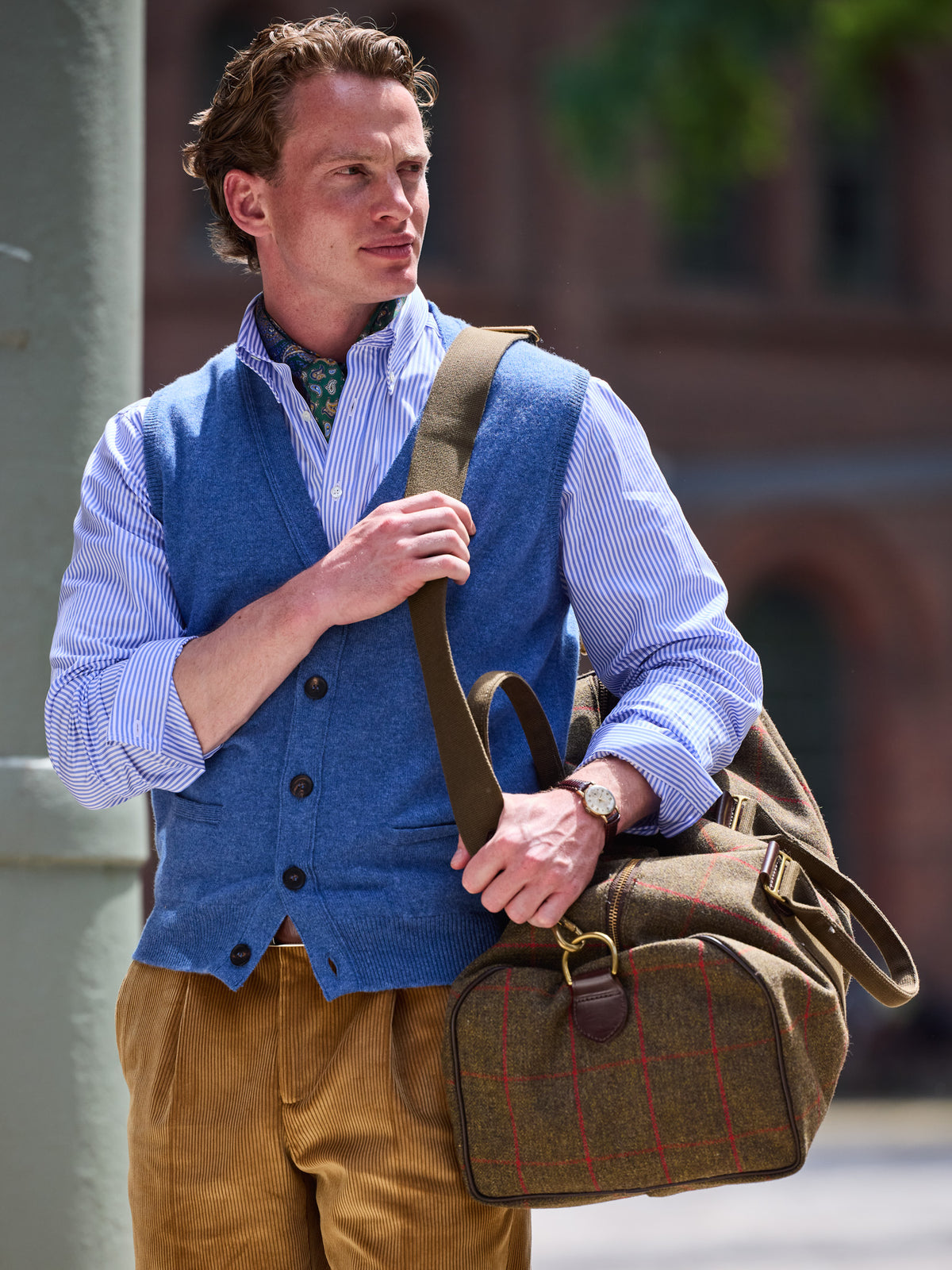 Weekender in Lovat Tweed, Olive, carried by the shoulder strap, windowpane check and leather tabs in detail – John Crocket