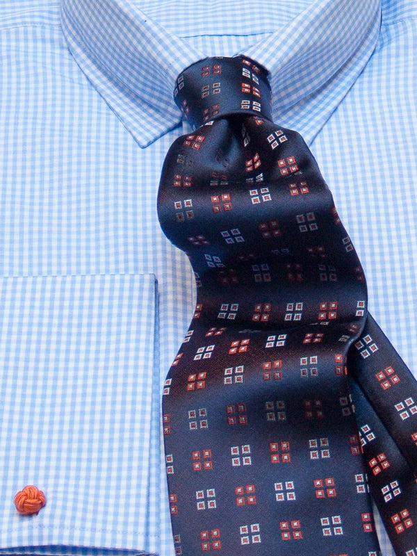 Silk tie patterned in navy/orange, detail view